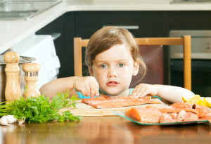 http://www.dreamstime.com/royalty-free-stock-images-child-raw-salmon-fish-kitchen-home-image34463939